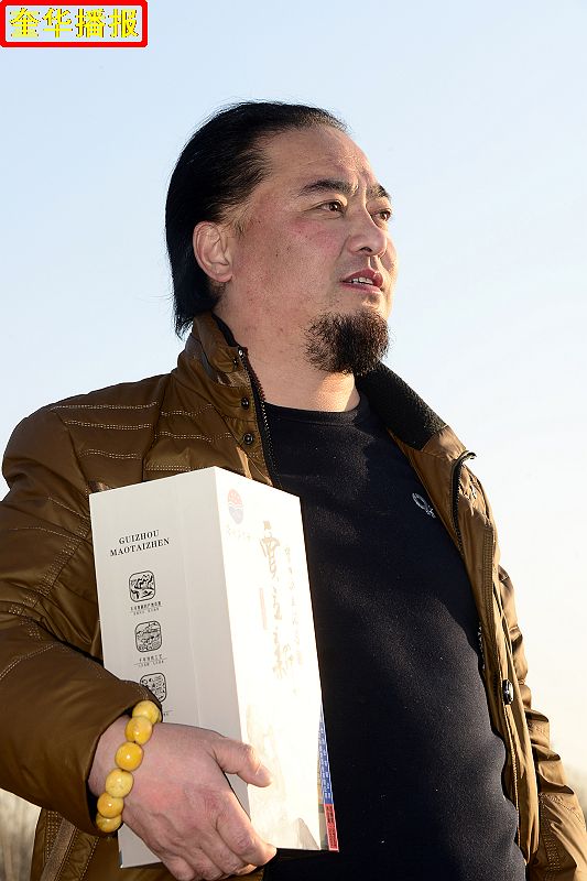书法家贾立新与他定制的茅台镇出产的“贾立新酒”。